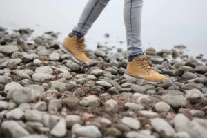 women's hiking boots walking over rocks